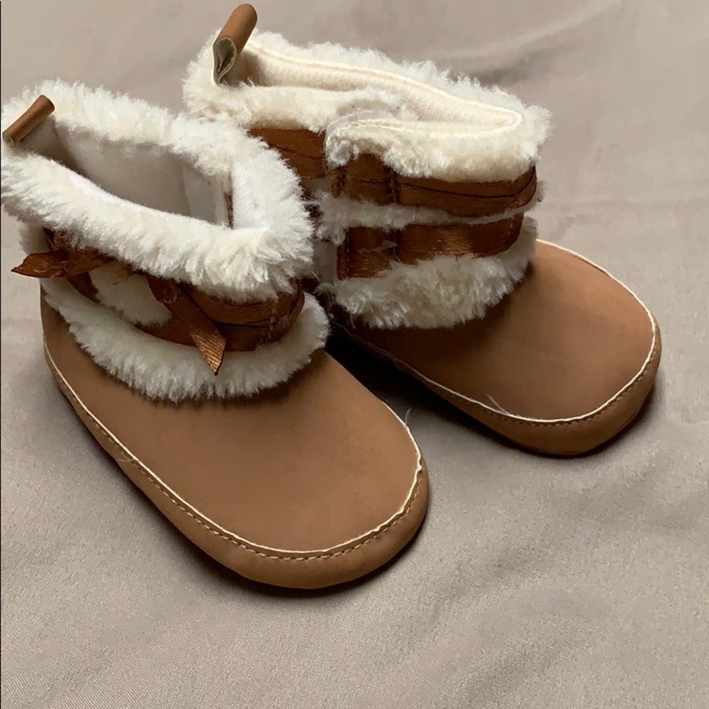 Tan baby boots with faux feather